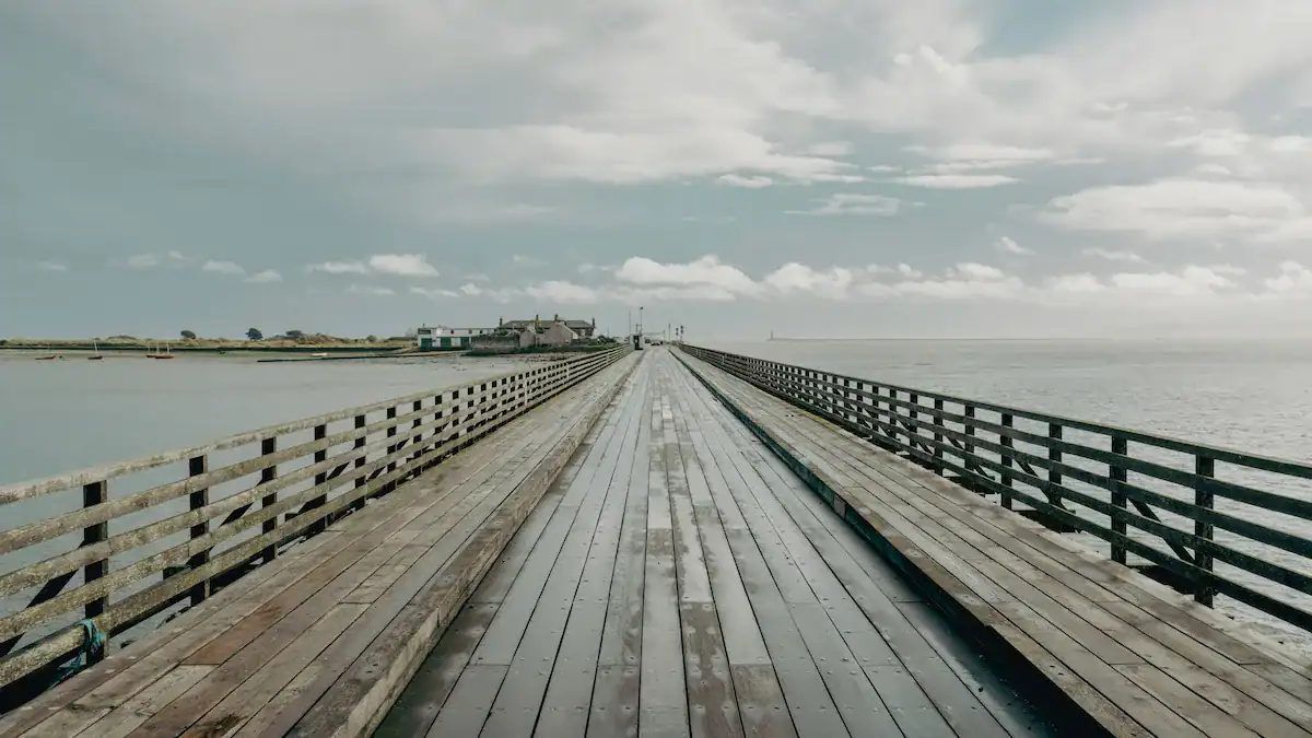A long wooden bridge stretching forward, symbolizing a two-year life change and intentional transition.