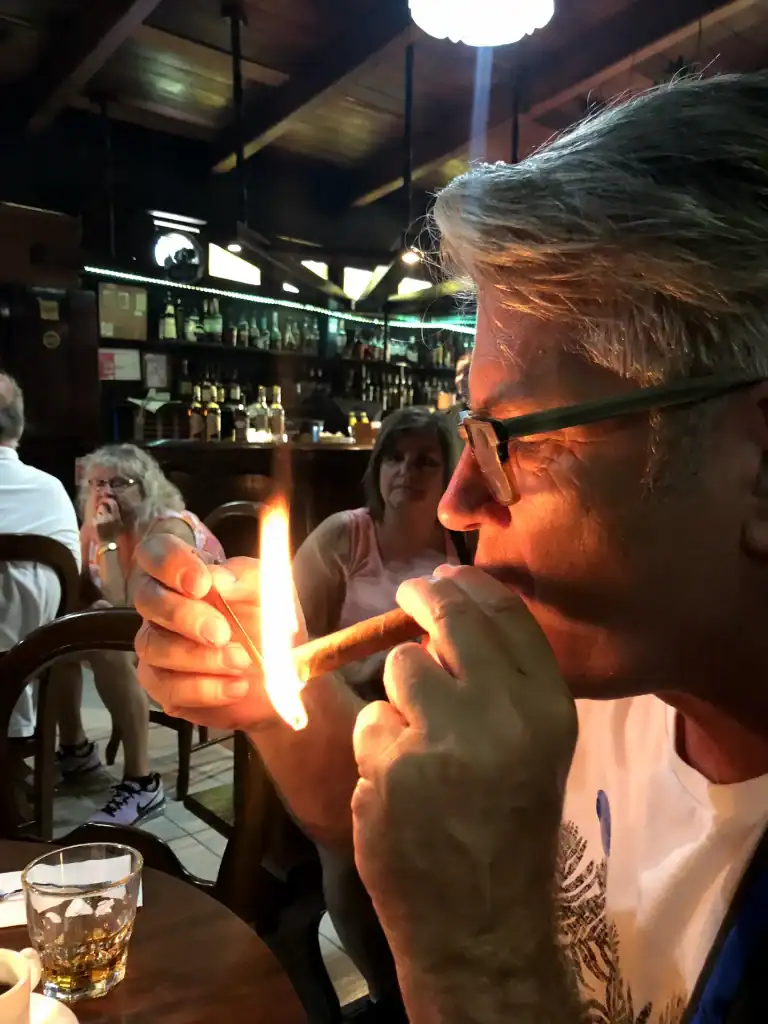 Matt lighting Cuban cigar the Cuban way at salsa cafe in Havana
