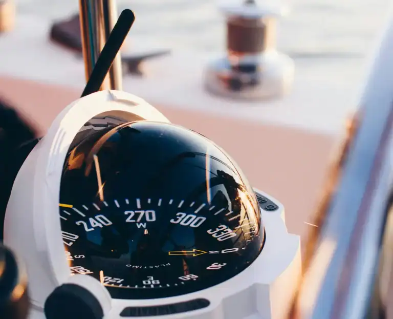 Boat compass showing navigation and course correction