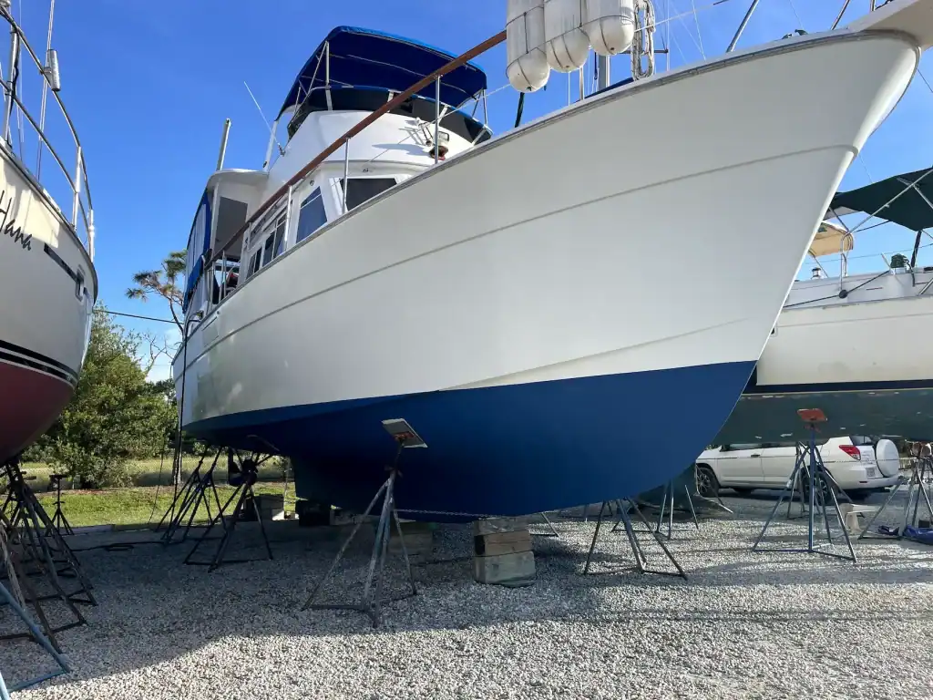 Motor yacht on stands with fresh bottom paint after repairs