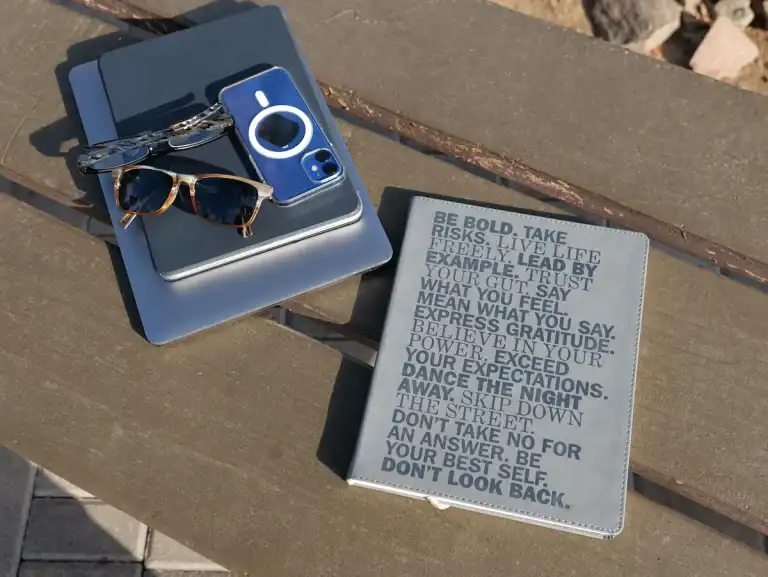 Journal and laptop on a bench, planning a next chapter as an empty nester