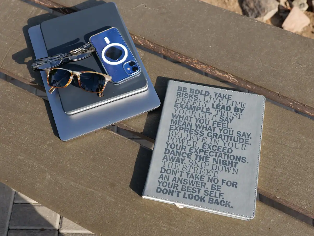 Journal and laptop on a bench, planning a next chapter as an empty nester