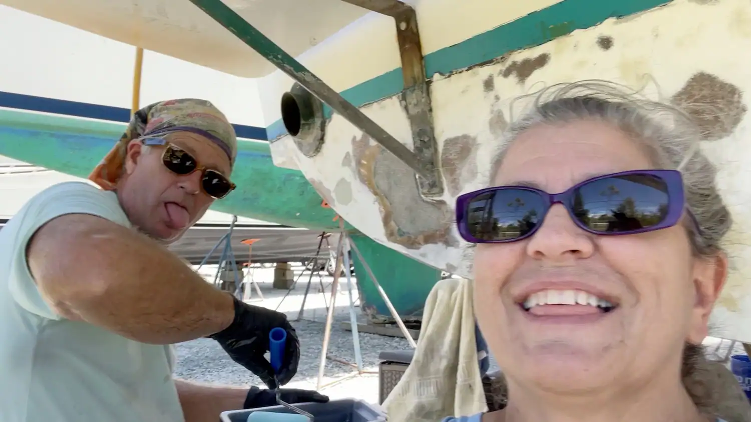 Matt and Linda Lutz grinning during a grueling boatyard repair day, a couple who learned real partnership in marriage means facing the hard work together